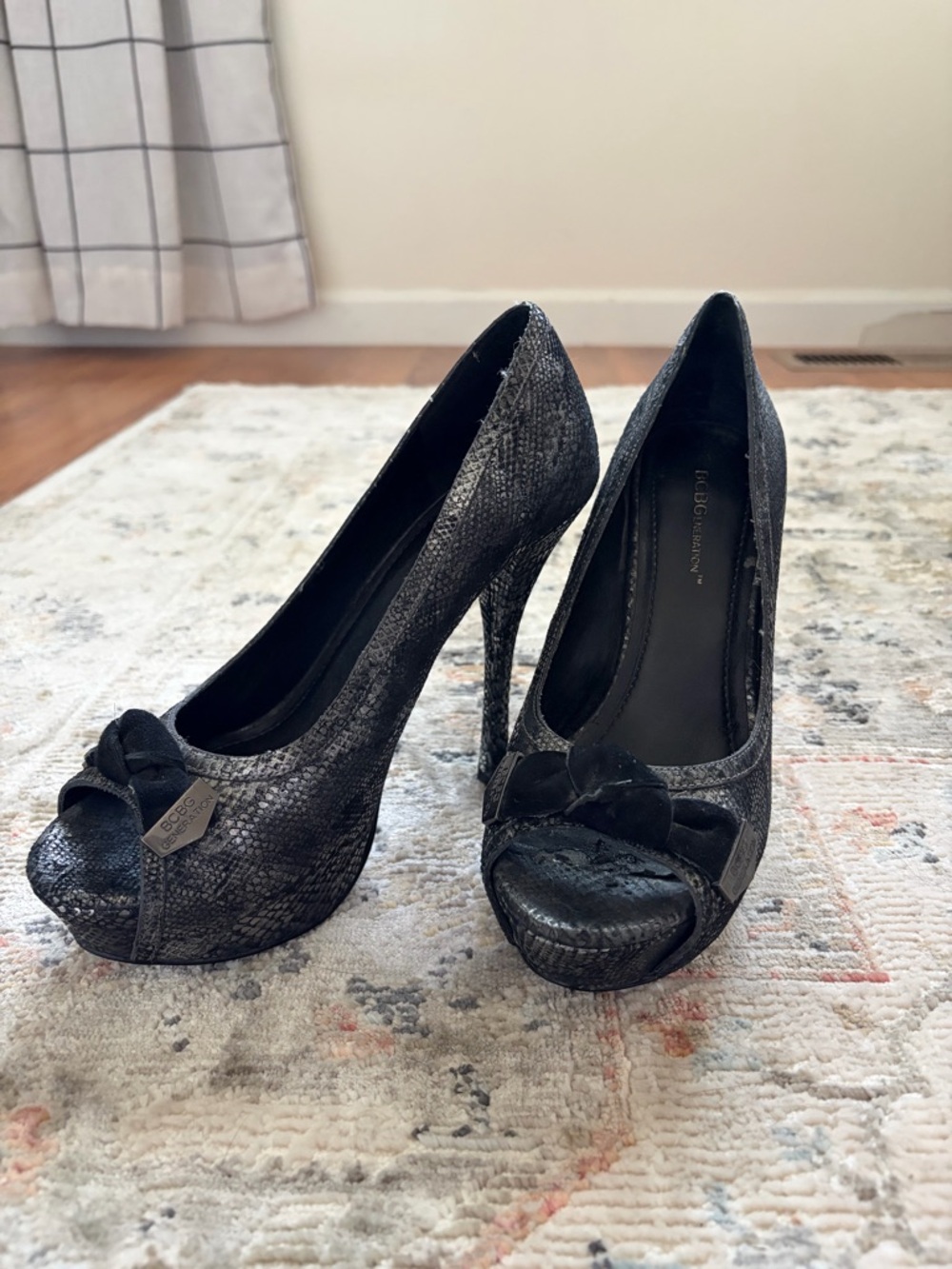 BCBGeneration Black Snakeskin Peep-Toe Platform Pumps with Bow